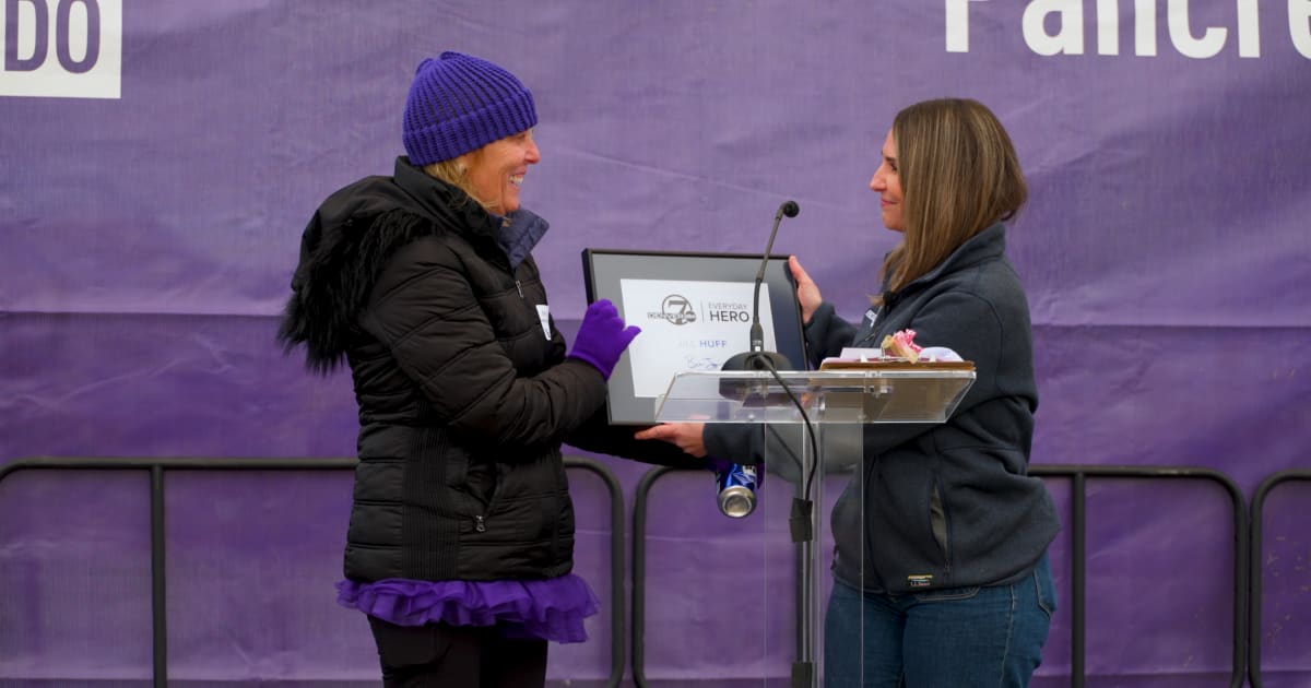 Jill Huff at PurpleStride Colorado event surrounded by pancreatic cancer survivors and supporters