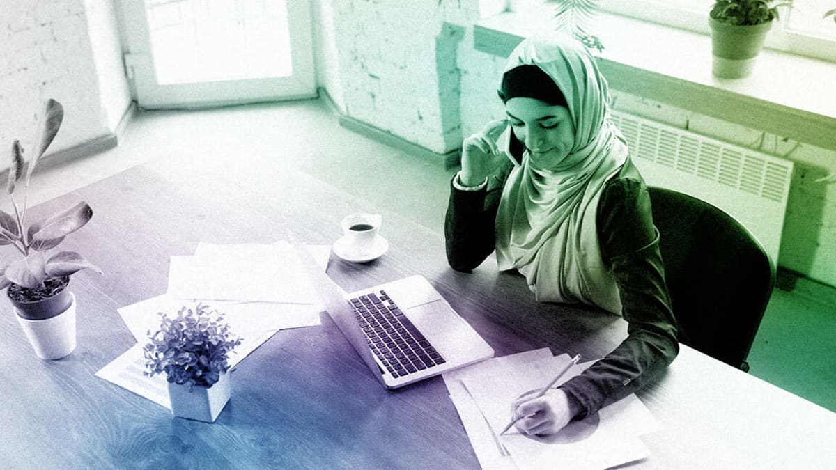 Emirati family collaborating together on business plans and documents at modern workspace