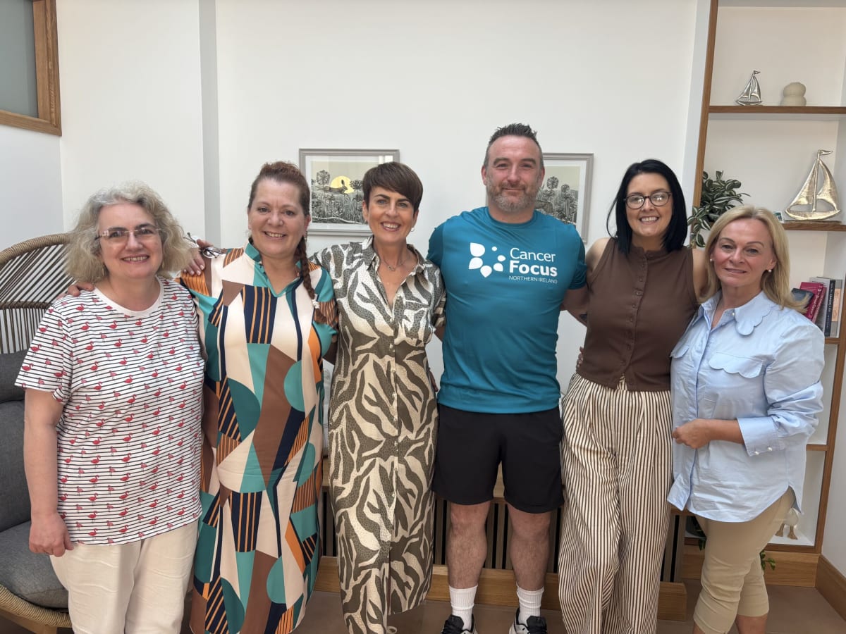 Cancer Focus support centre volunteers welcoming visitors at bright, open Enniskillen facility entrance