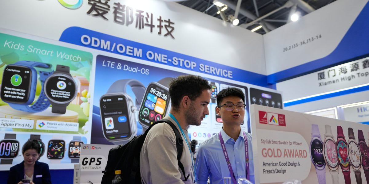 Modern factory production line in China with workers assembling electronics and automotive components