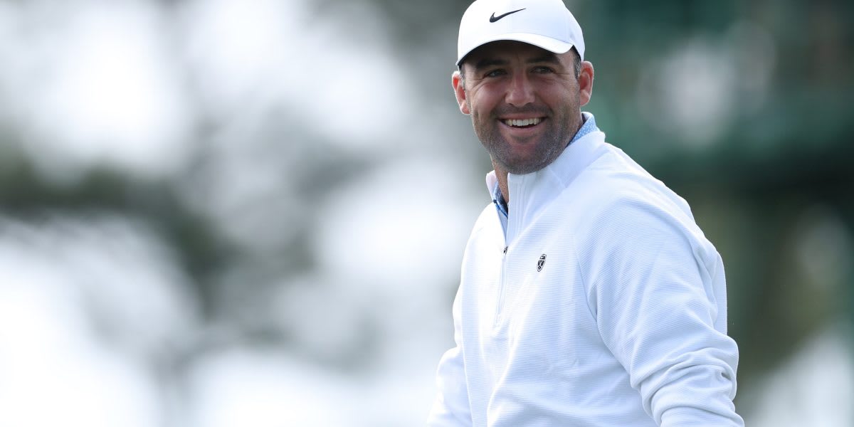 Scottie Scheffler smiling on golf course celebrating victory with charitable giving impact