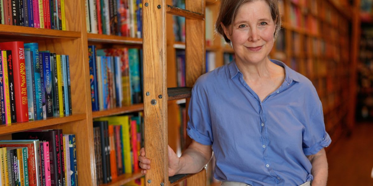** Author Ann Patchett standing inside Parnassus Books surrounded by shelves and community