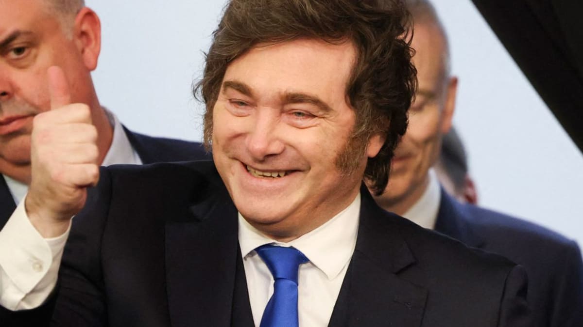 Argentine family shopping at outdoor market with fresh produce and goods displayed