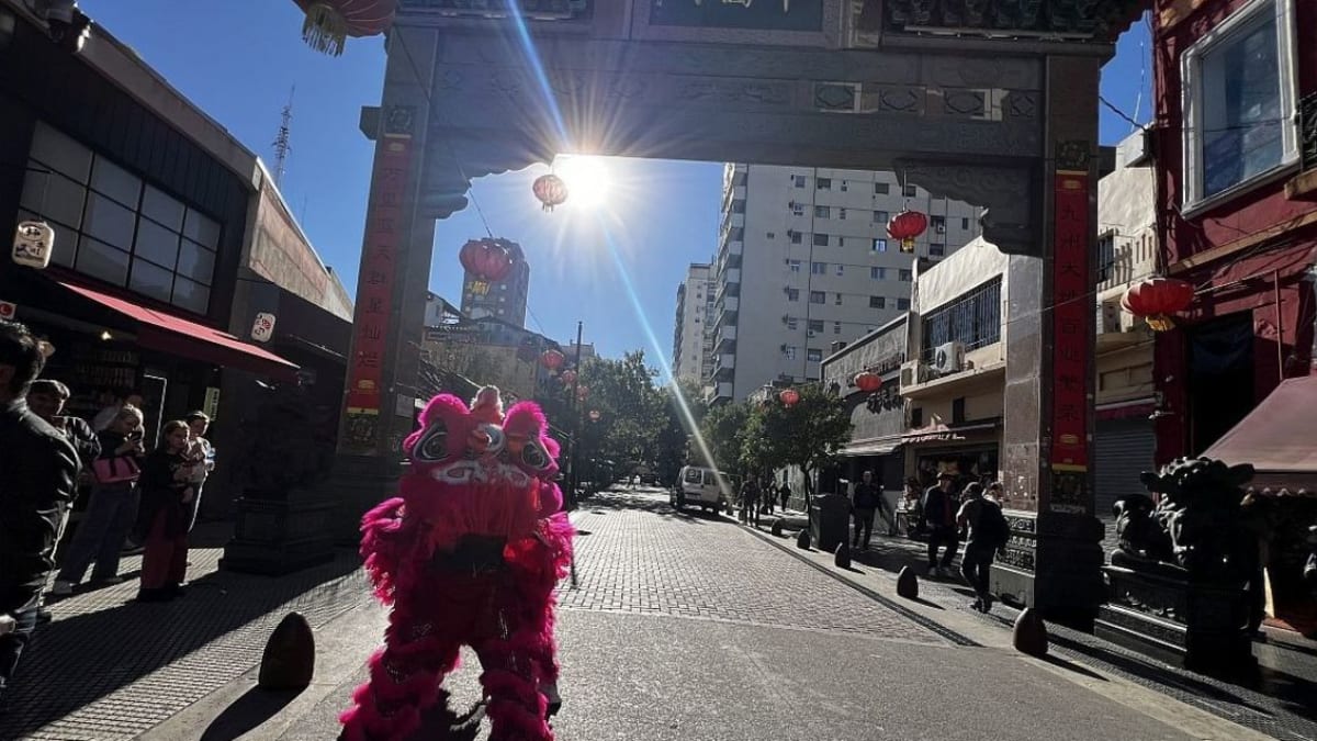Red and gold Chinese arch with stone lions guarding entrance to Barrio Chino in Buenos Aires