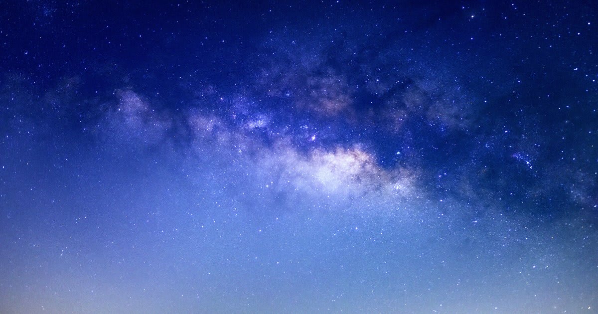 Artistic rendering of dwarf galaxy merging with larger Milky Way galaxy in deep space
