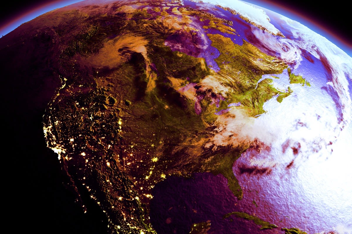 Scientists working at computers with climate data visualizations and weather patterns displayed on screens