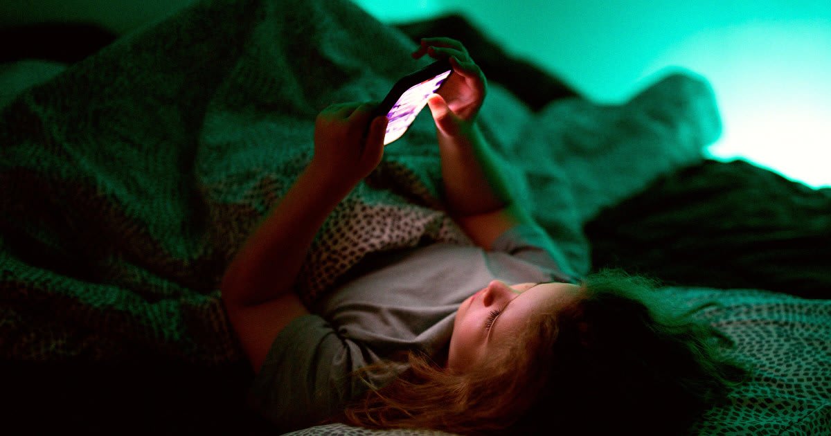 Teenager holding smartphone with Instagram app displaying new time limit notification screen