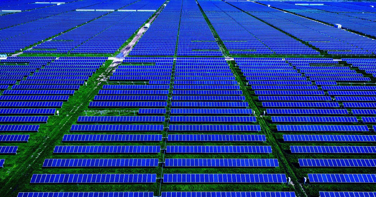 Solar panel arrays stretching across Texas landscape under bright blue summer sky