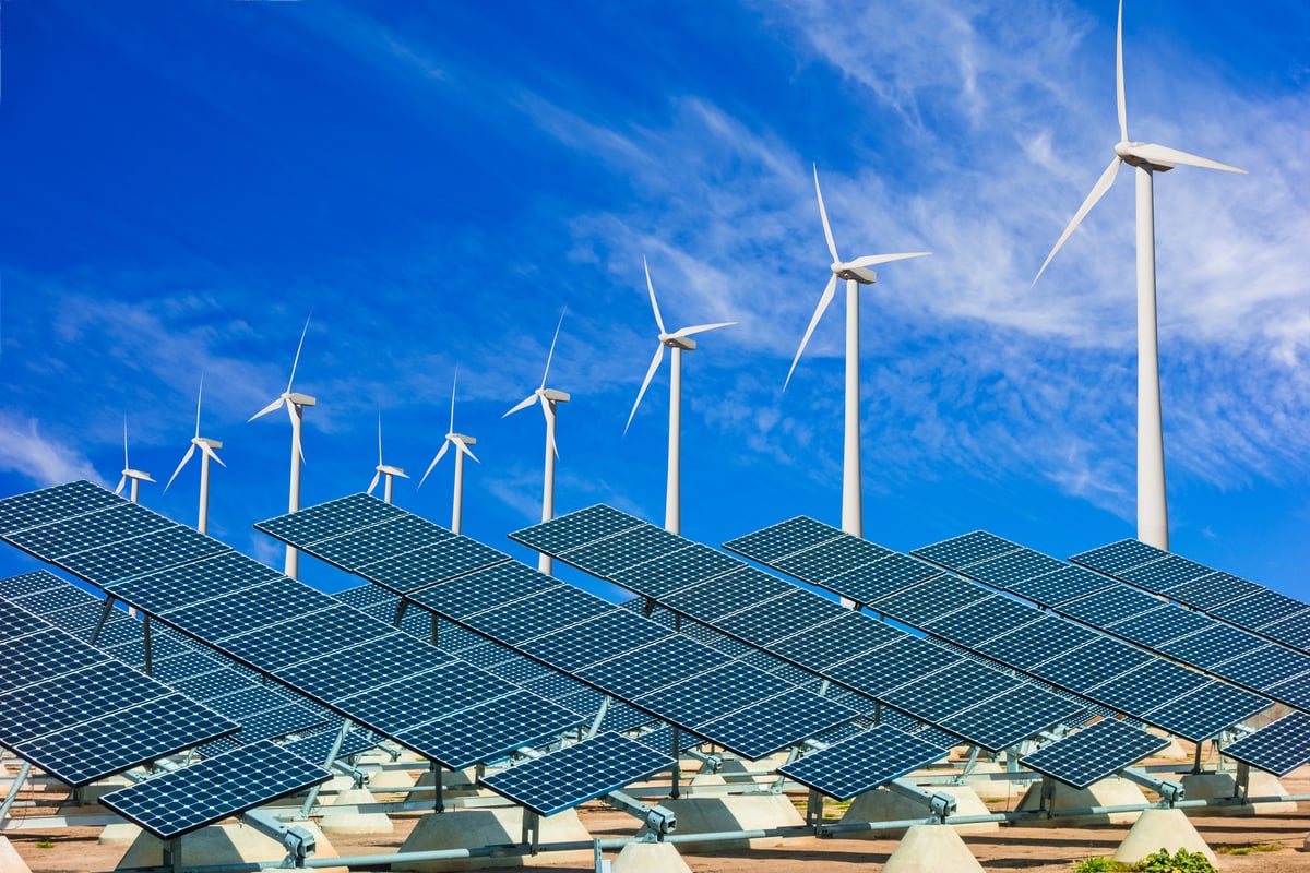 Solar panel array gleaming in sunlight against blue sky generating renewable electricity
