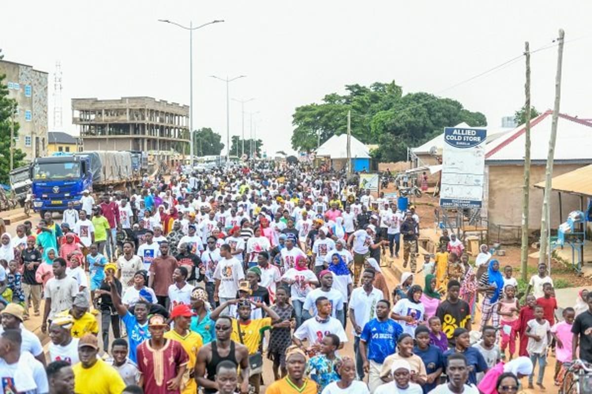 Large group of diverse participants walking together during Damba health celebration in Bimbilla Ghana