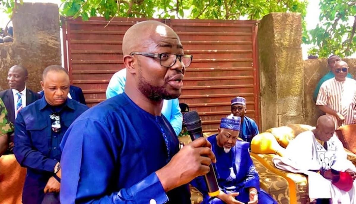 Nigerian families gathered at community center receiving coordinated support services under new poverty reduction program