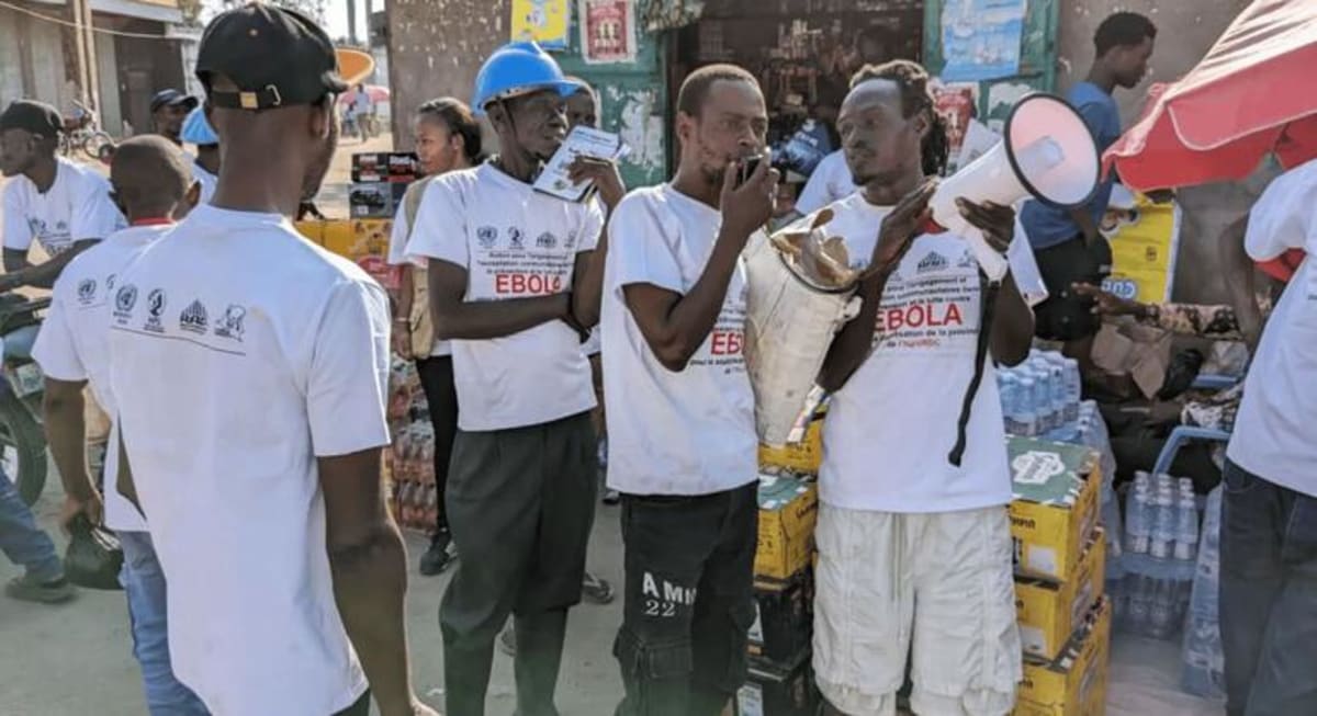 Former rebel fighters in DR Congo speak with community members about Ebola prevention measures