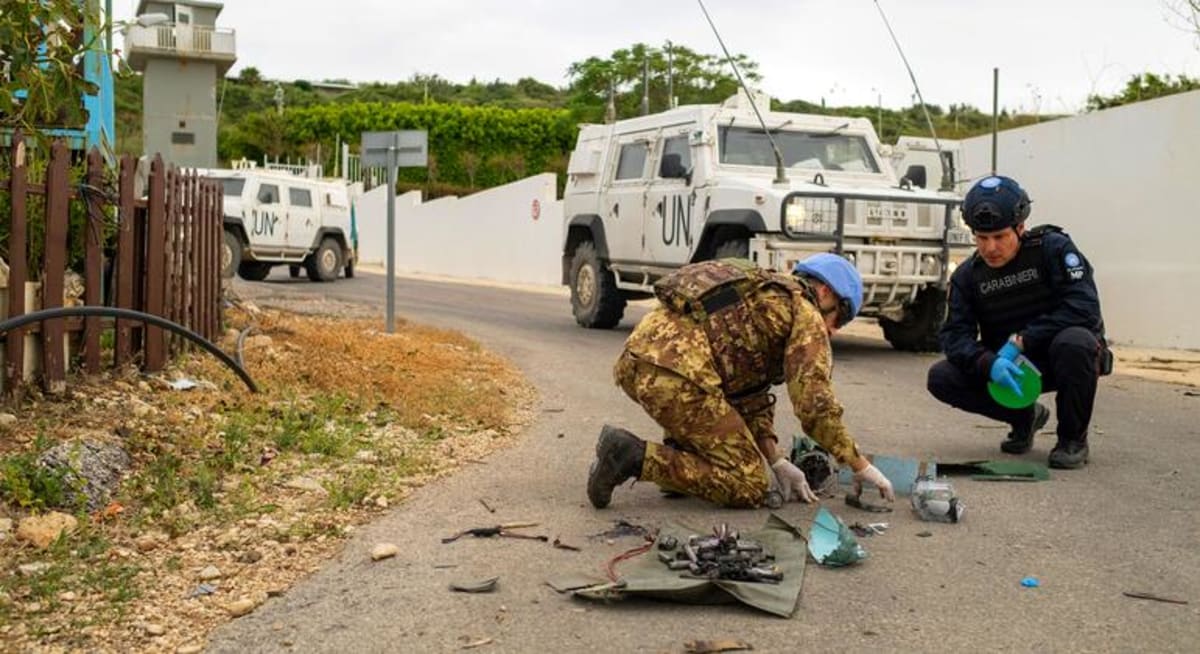 UN peacekeepers in Lebanon examining equipment while supporting humanitarian operations in southern villages