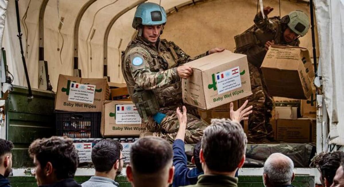 UN peacekeepers in blue helmets delivering humanitarian supplies to Lebanese villagers in southern Lebanon