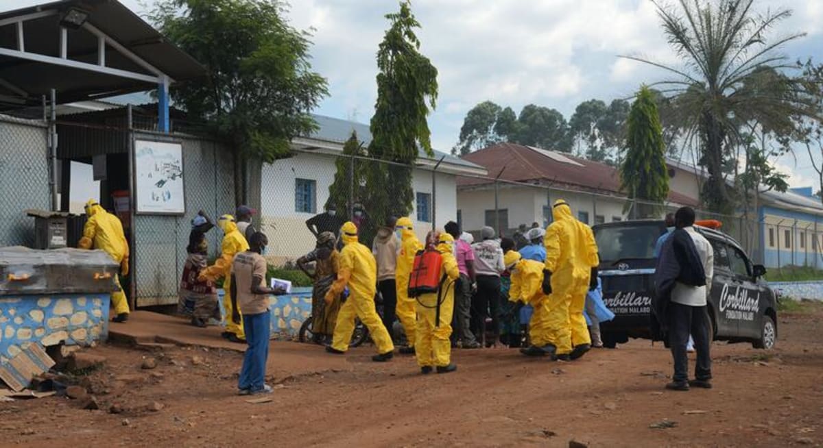 ** Health workers in protective equipment preparing Ebola testing samples in mobile laboratory facility in Congo