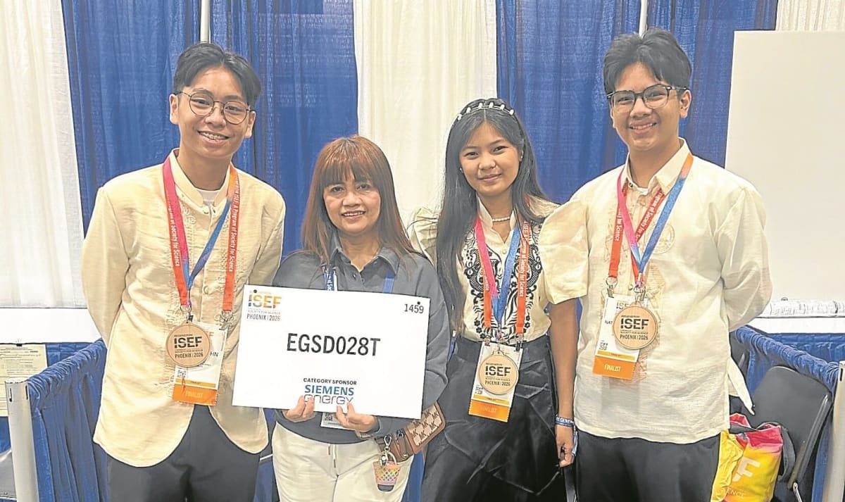 Three Filipino students and their coach celebrate their international wind energy award in Phoenix, Arizona