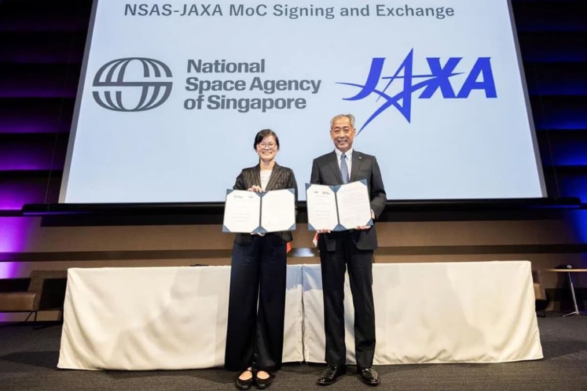 Singapore and Japanese space agency leaders shake hands after signing historic cooperation agreement in Tokyo
