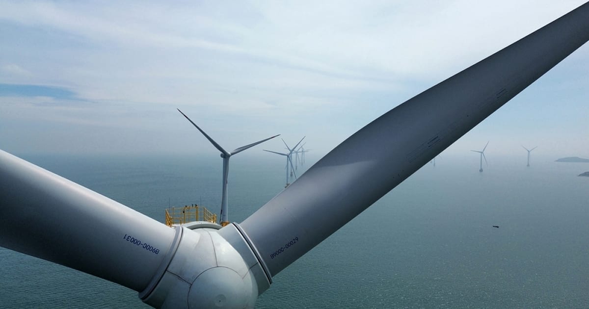 Modern offshore wind turbines standing tall in ocean waters generating clean renewable energy