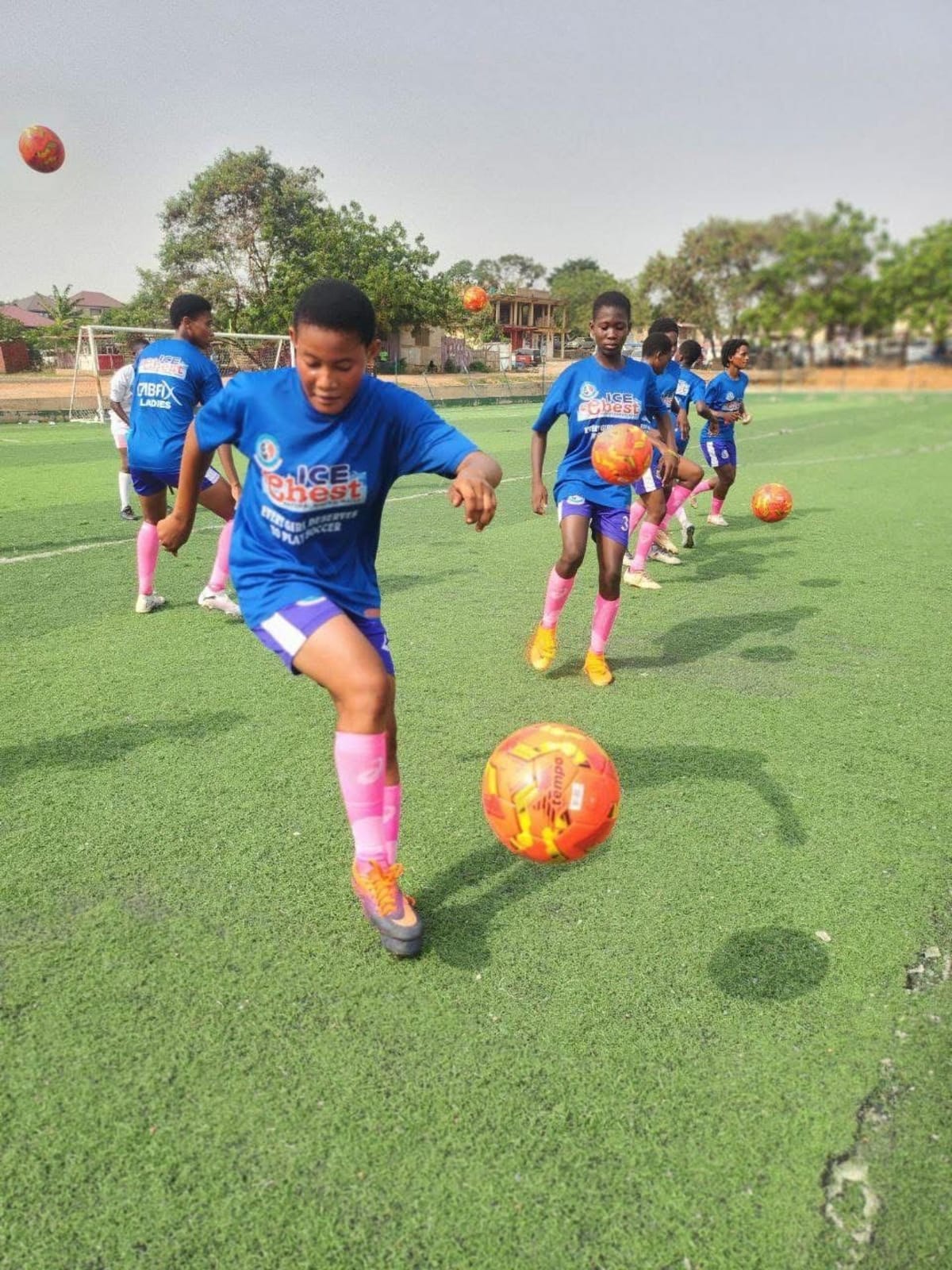 Young girls playing football in Ghana as part of youth development program