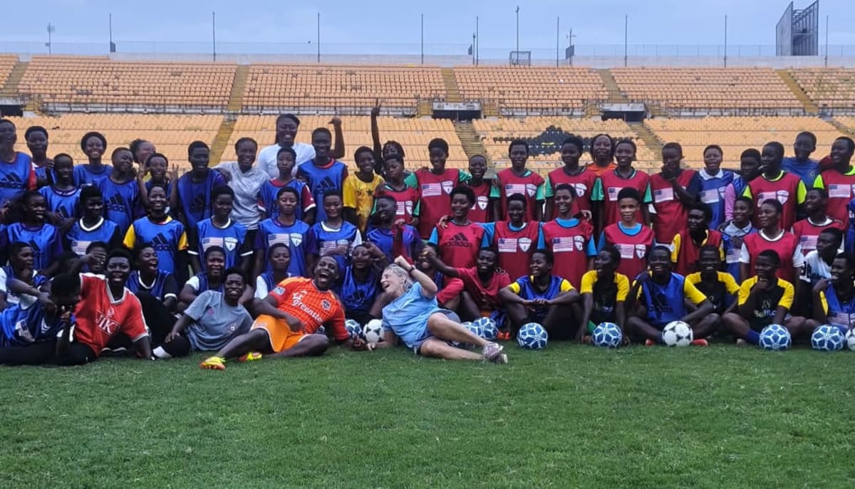 Female coaches and young players training together on football field in Kumasi Ghana