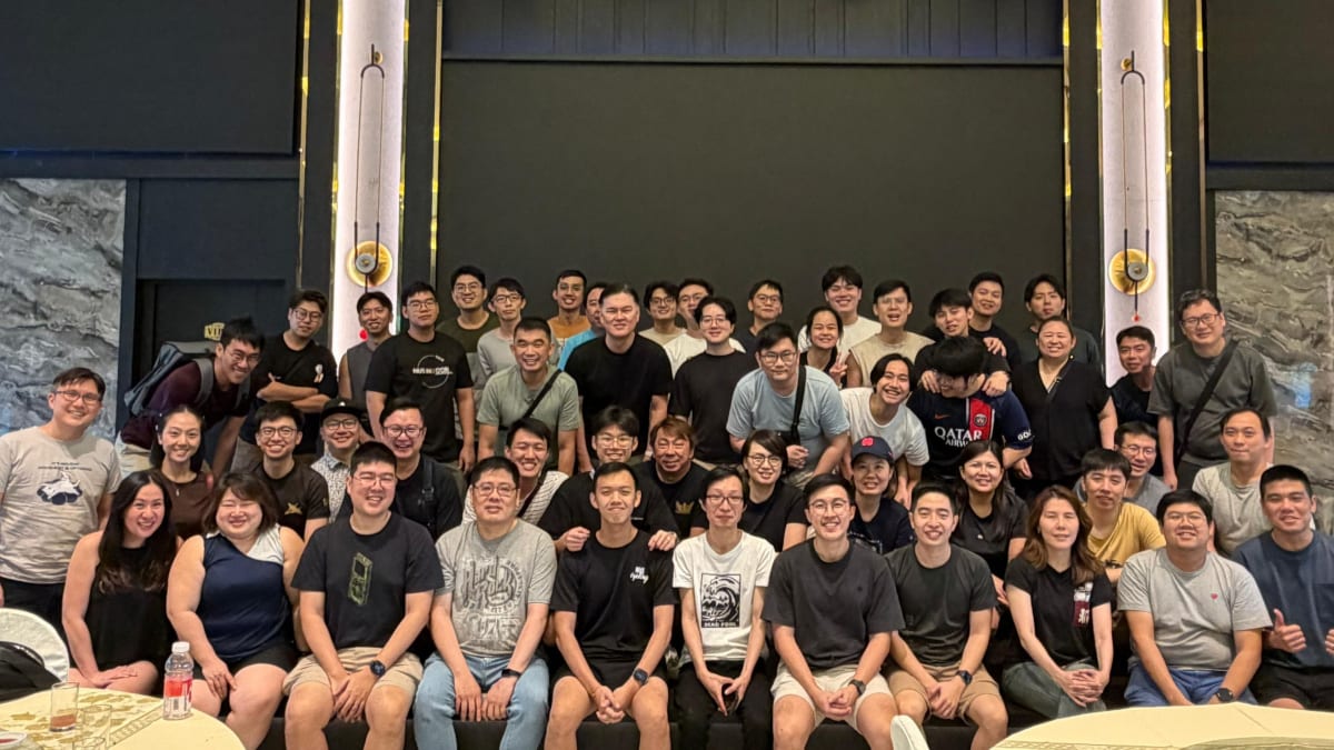 ** CAPE team members from Singapore's Defence Science and Technology Agency standing together at innovation symposium