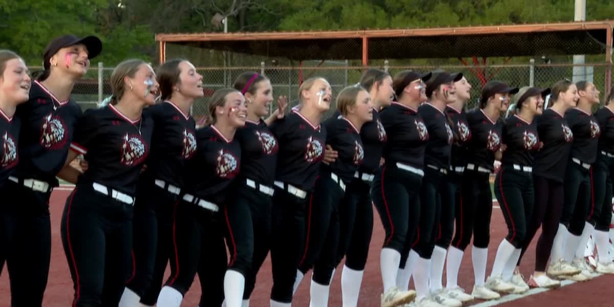 Tioga Lady Indians softball team celebrating their district championship victory with trophy
