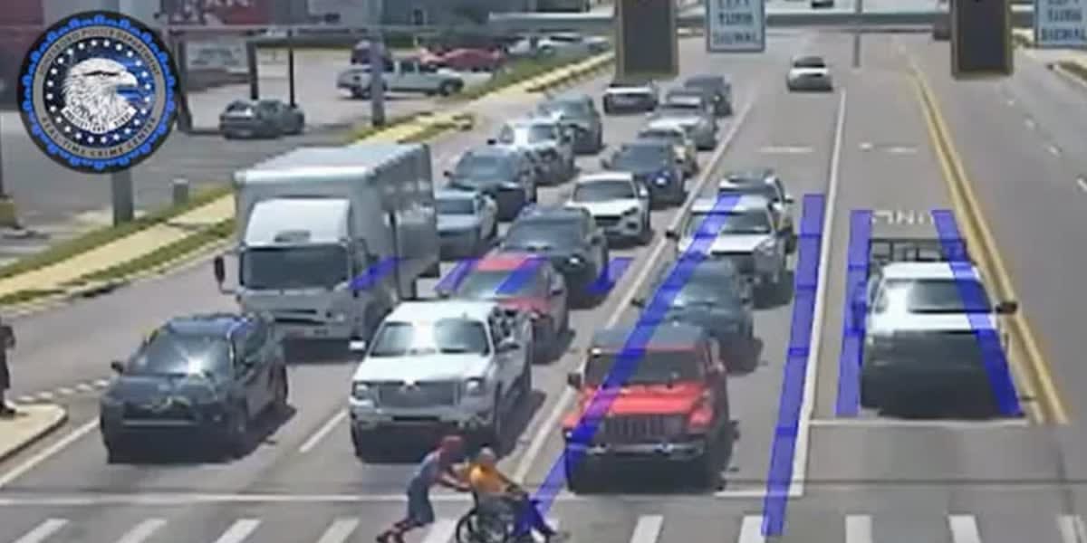 Traffic camera footage shows person in Spider-Man costume helping wheelchair user cross street safely