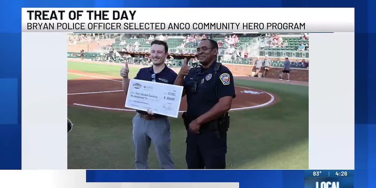 Bryan police officer in uniform throwing first pitch at Texas A&M baseball game
