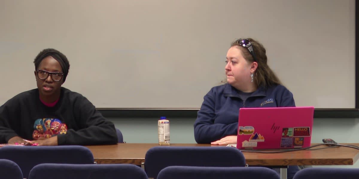 Diverse group of volunteers and immigrant families gathering together in welcoming community event