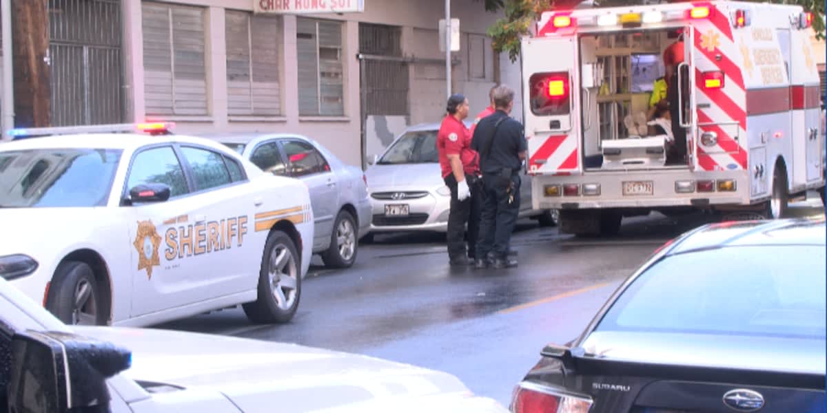Crisis outreach team speaking with person on Honolulu street, offering compassionate mental health assistance