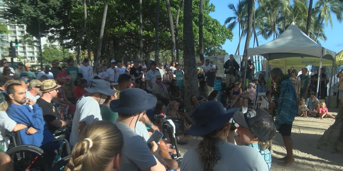 Kenji Nonaka smiling at Hawaii Adaptive Surfing Championships with surfboard and prosthetic leg