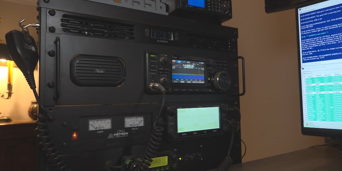 Amateur radio operator Brandon Kimbrell at his home station with world map showing international contacts