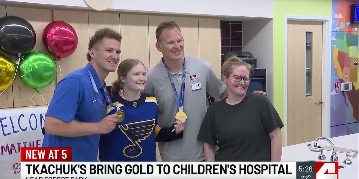 Matthew and Brady Tkachuk showing Olympic gold medals to children at St. Louis hospital