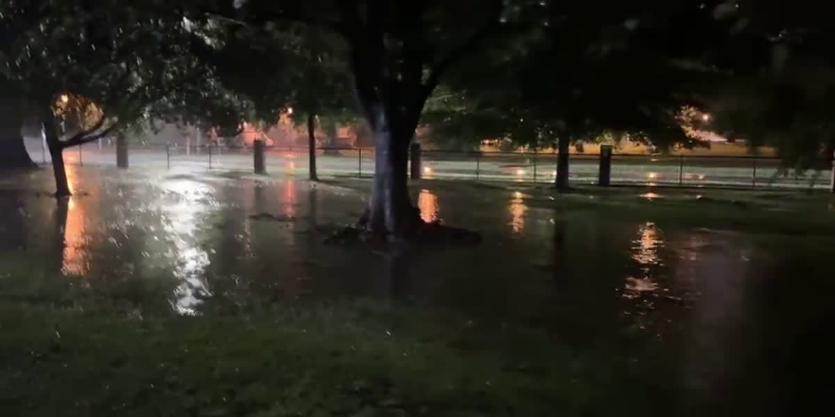 Cajun Navy volunteers in rescue boat navigating flooded Biloxi River during tropical storm