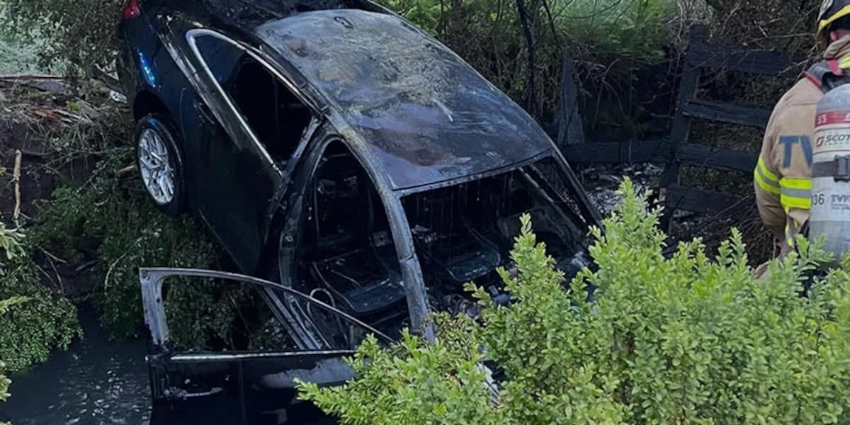 Burned vehicle wreckage after creek crash rescue in Wilsonville Oregon Sunday night