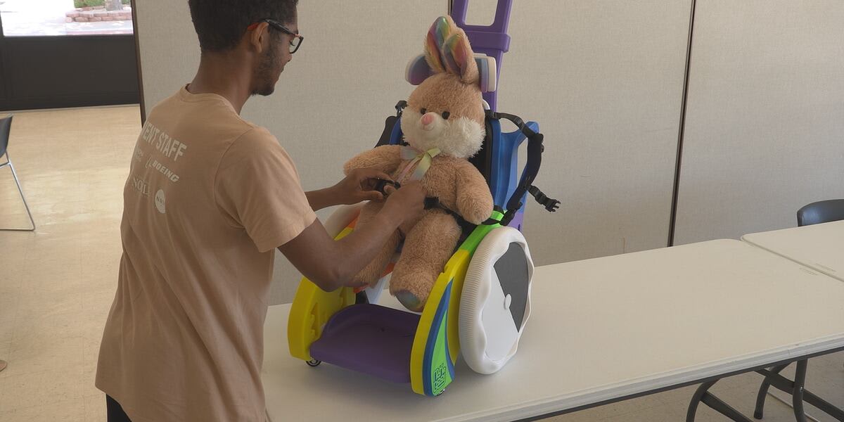 Teen volunteers working with 3D printer creating mobility device at public library