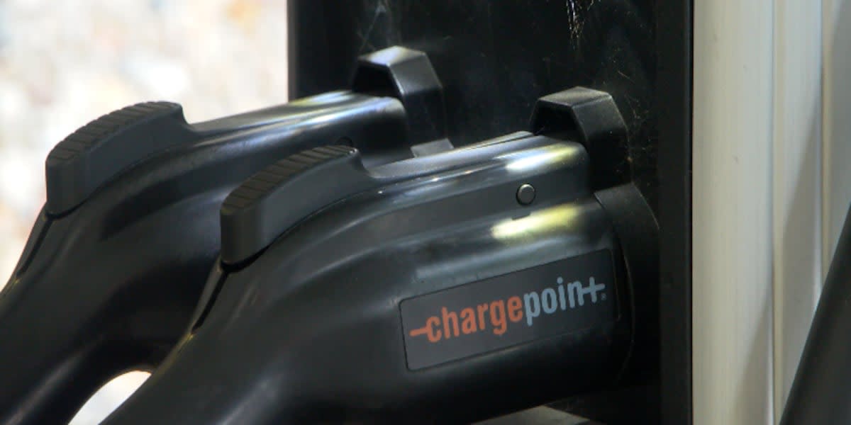 Electric vehicle charging at a fast-charging station along a Minnesota highway