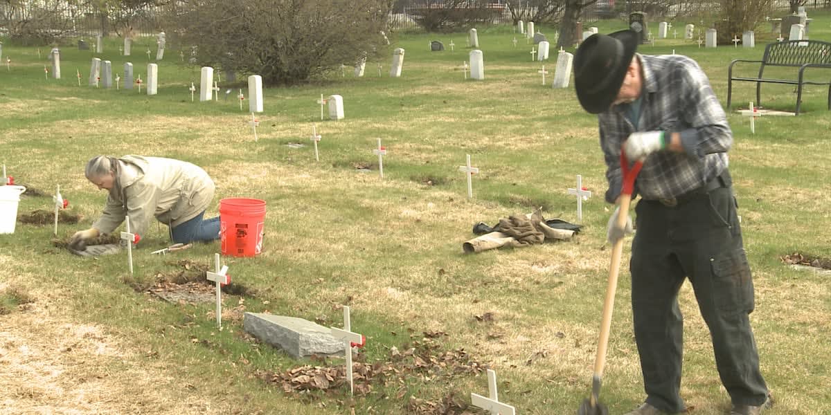 Volunteers cleaning veteran headstones at Anchorage Memorial Park Cemetery before Memorial Day