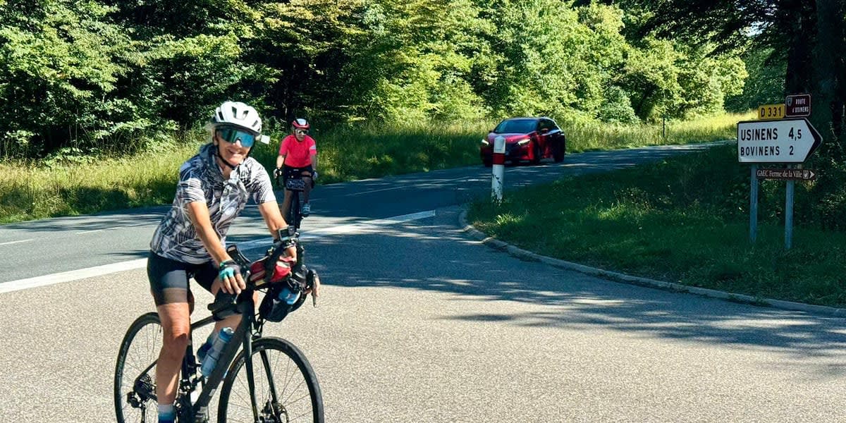 Elderly woman cyclist Lynn Salvo standing with bicycle during world record journey