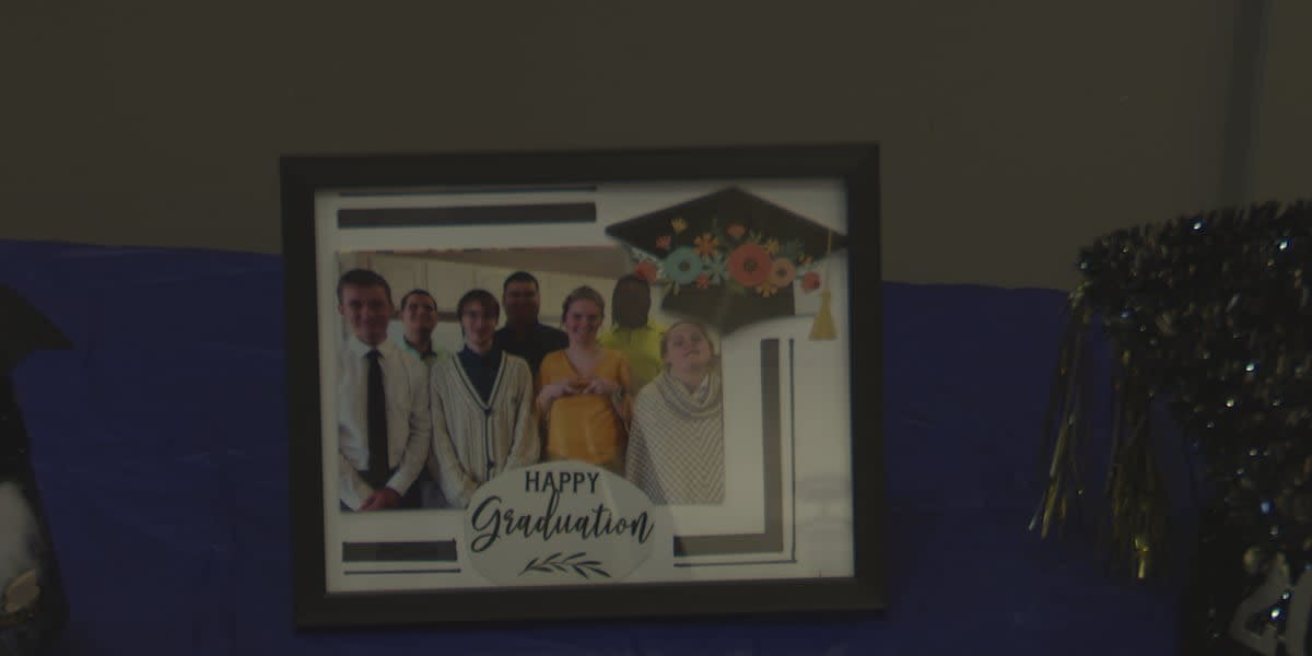 Seven young graduates in caps and gowns celebrate completing Project SEARCH internship program