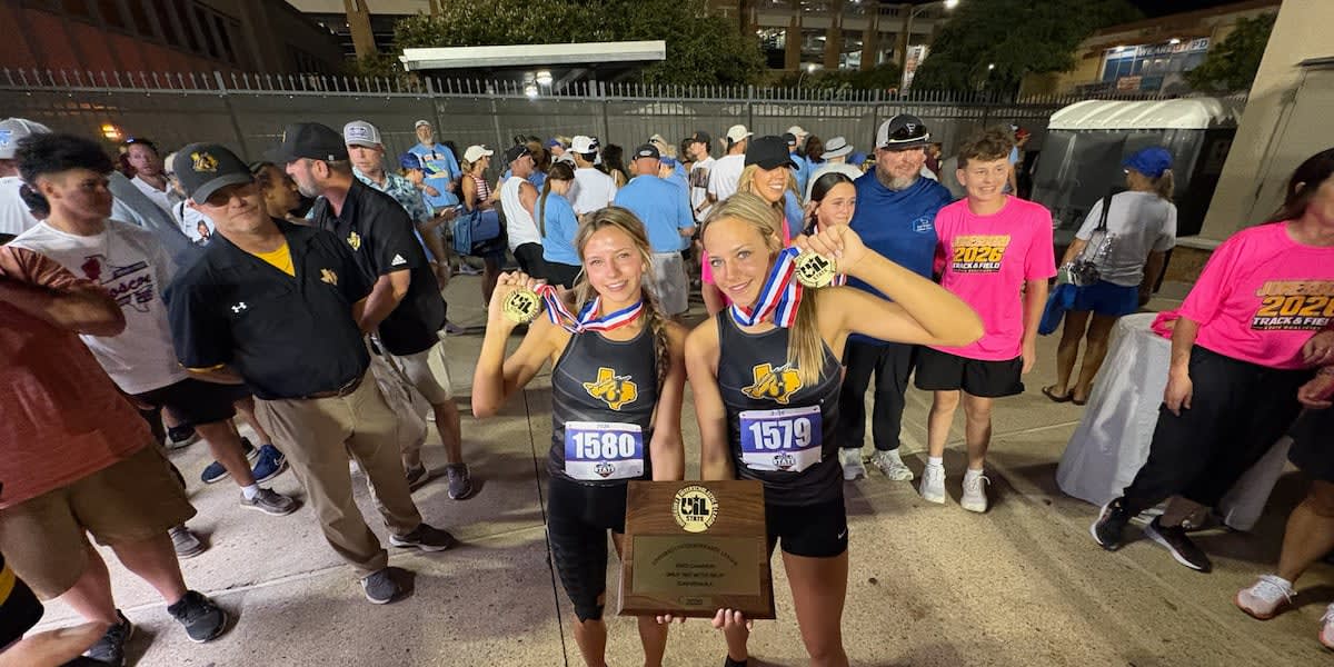 Two teenage sisters in track uniforms celebrating together after winning state championship relay race