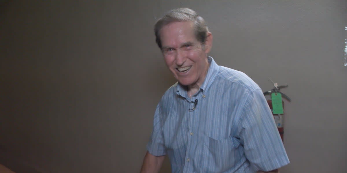 Elderly man climbing church stairs with determination, tracking progress on chalkboard nearby