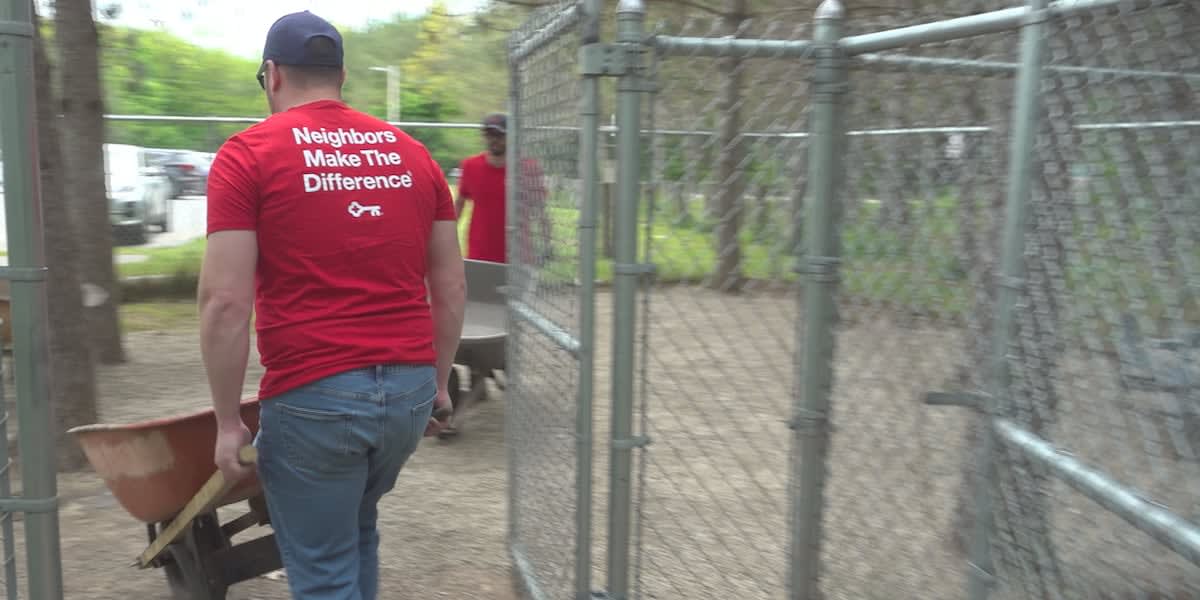 KeyBank volunteers spreading gravel at Bangor Dog Park during community service day