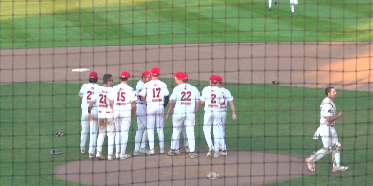Young baseball players in Riverhawks uniforms celebrating their undefeated state championship victory in Maine