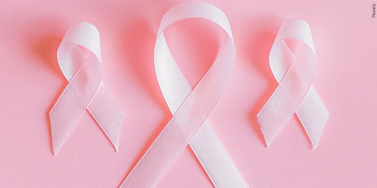 Pink and white sneakers at formal event supporting breast cancer survivors and fighters