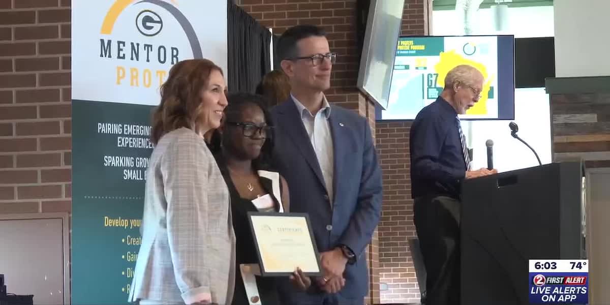 Green Bay Packers mentor-protégé program participants celebrating at graduation ceremony with business mentors