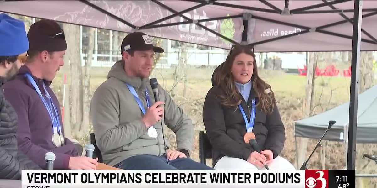 Three Olympic skiers holding medals at community celebration in Stowe, Vermont