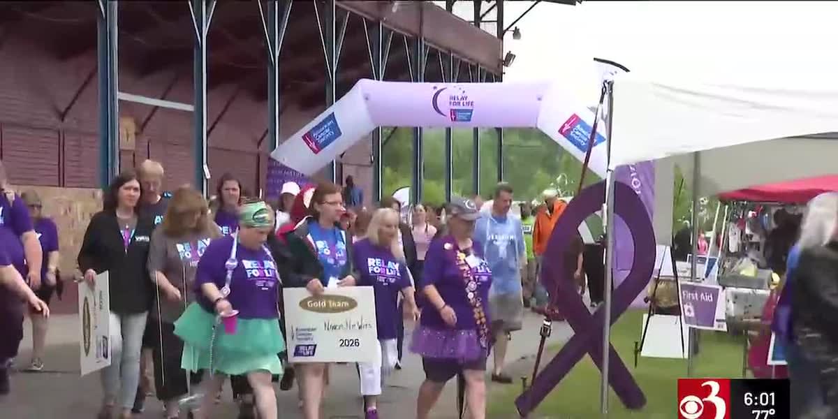 Hundreds of relay participants walking on outdoor track during Rutland Vermont cancer fundraising event