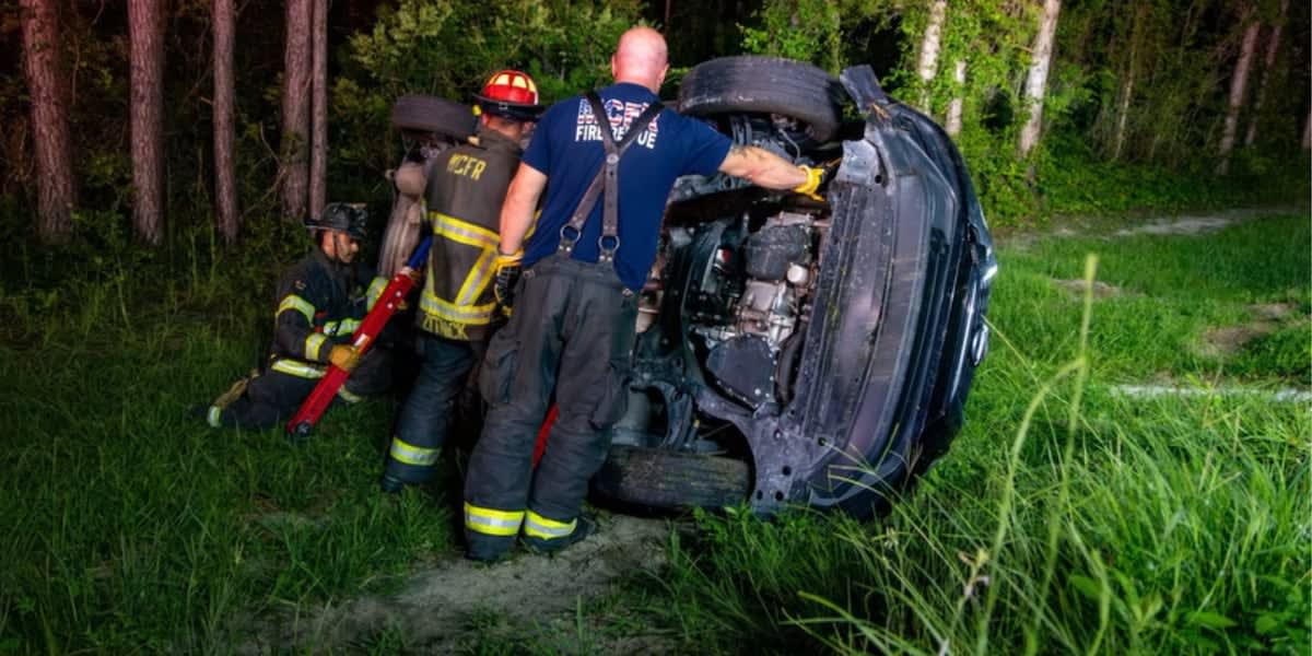 Overturned vehicle on Florida roadway after rollover crash in Ocklawaha at night