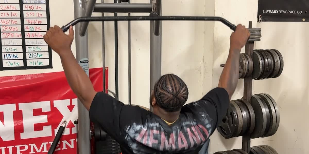 Lorenzo Wright preparing to squat with heavy barbell during powerlifting competition